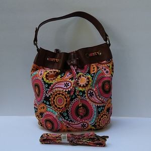 An fabric with leather tote purse.